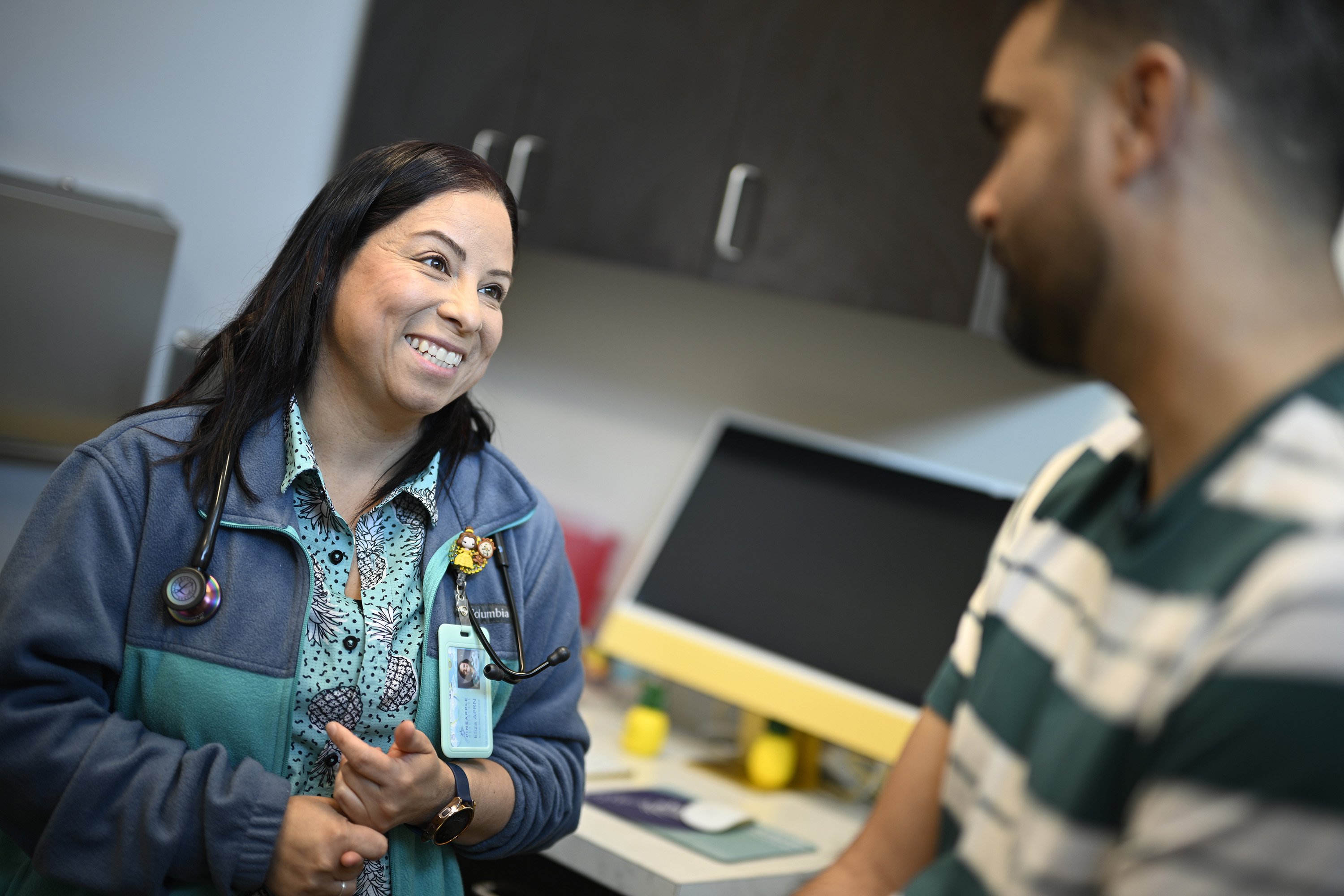 Nurse practitioner Eliza Otero (left) talks with Fernando Hermida at...