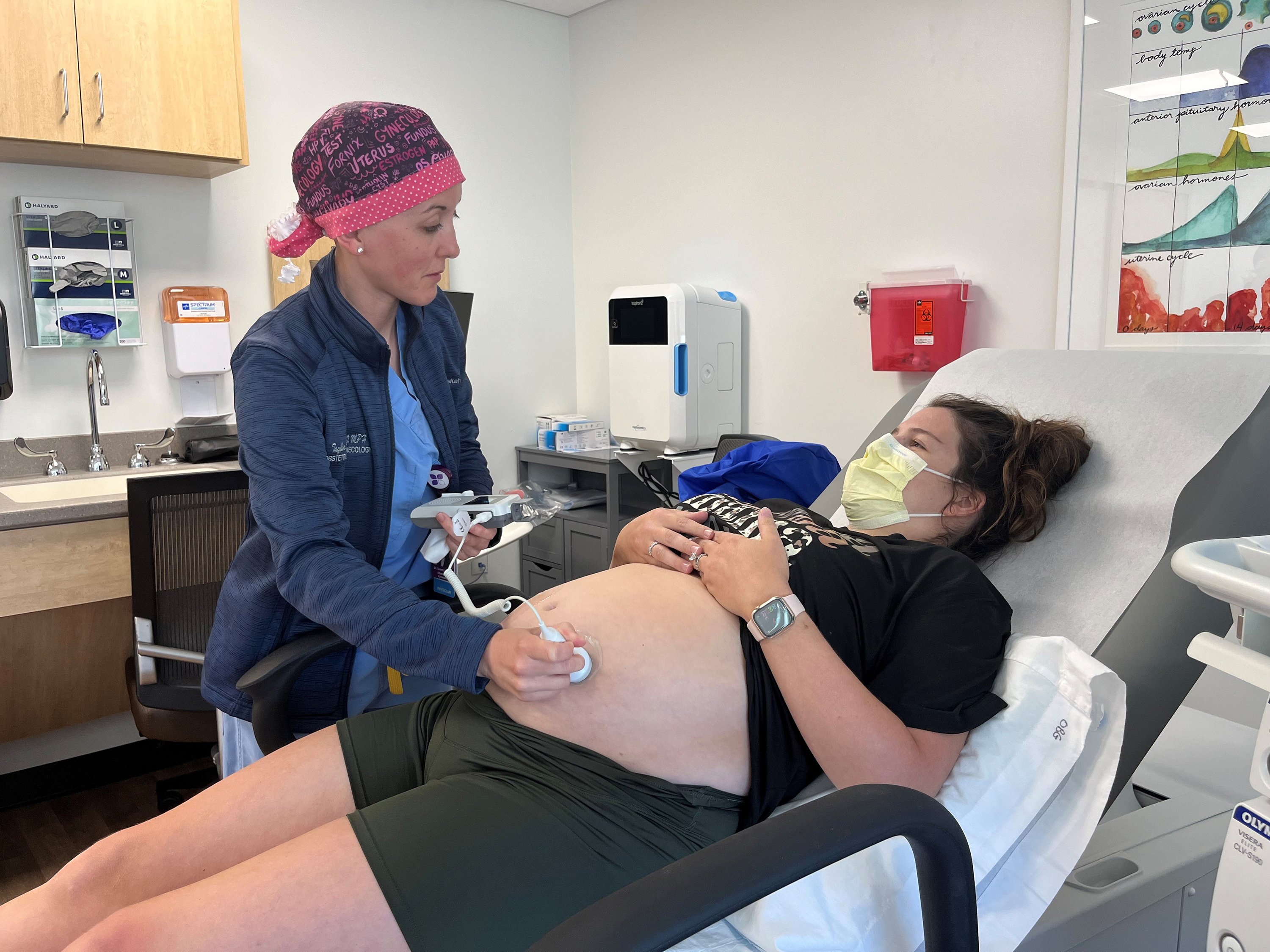 Obstetrician and gynecologist Taylar Swartz uses an ultrasound scanner to...