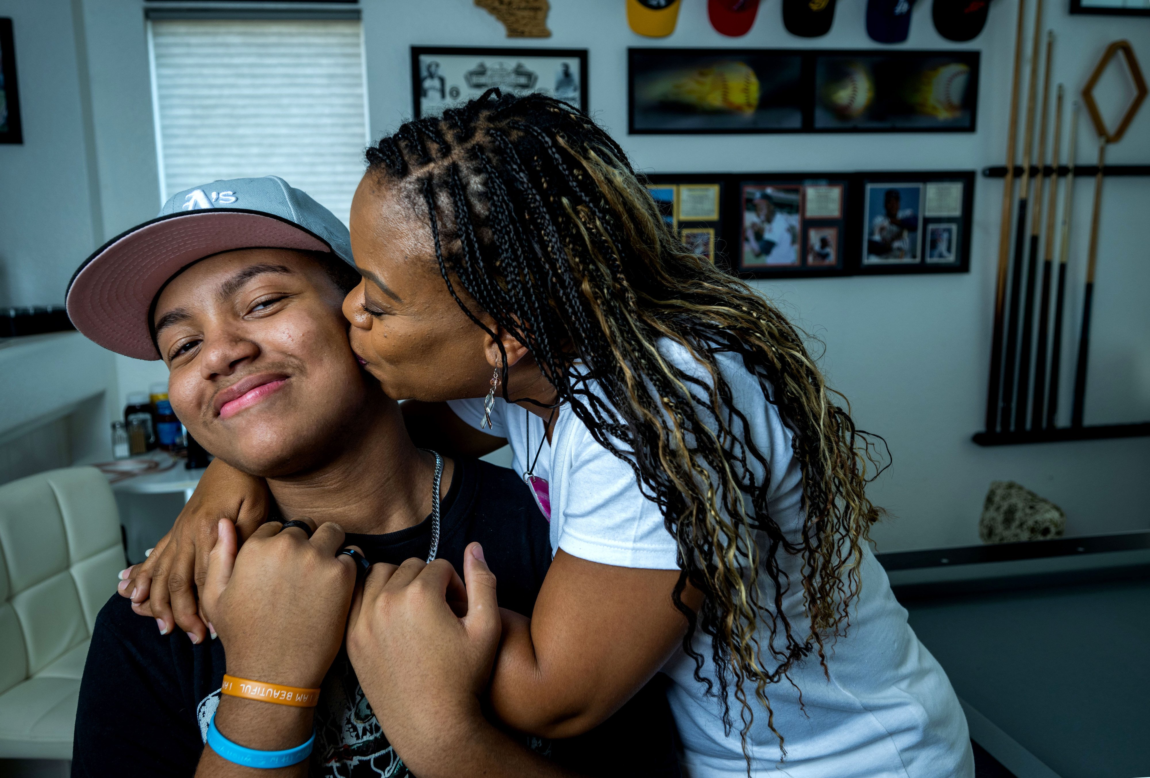 Cancer survivor, author and motivational speaker Tasha Champion kisses her...